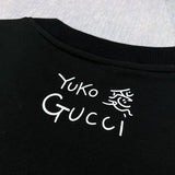 Front view of Gucci luxury clothing with signature branding