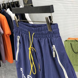 Flat lay presentation of Rhude luxury clothing with logo-detail design