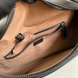 Close-up detail of structured polished women's handbag – women's statement bag