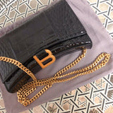 Side profile of sleek polished women's handbag – women's luxury handbag