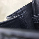 Side view of poised structured handbag