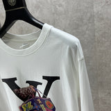 Full styled look of Louis Vuitton luxury clothing with monogram-inspired silhouette