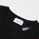 Close-up detail shot of Rhude luxury clothing with monogram-inspired silhouette