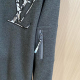 Front view of Louis Vuitton luxury clothing with label-forward styling