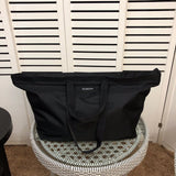 Side profile of elevated sleek women's handbag – women's luxury handbag