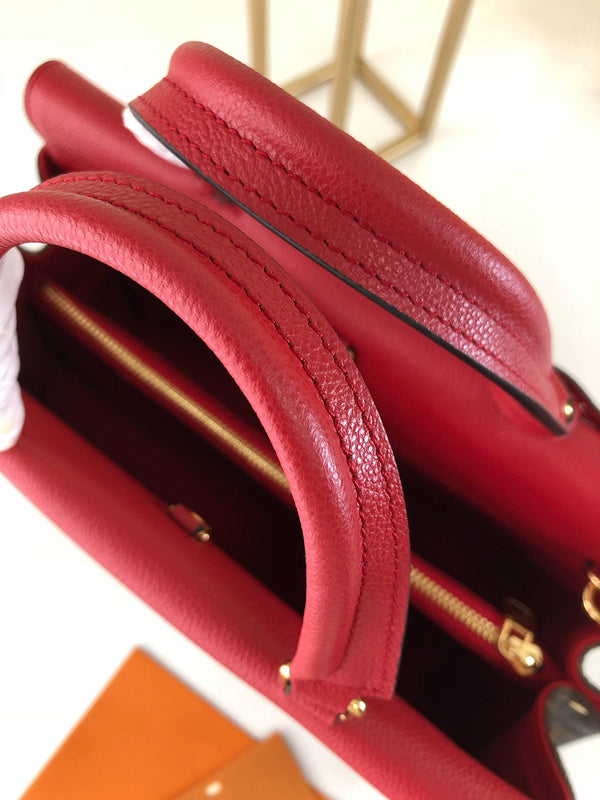 Handle and strap detail of classic elevated women's handbag – women's statement bag