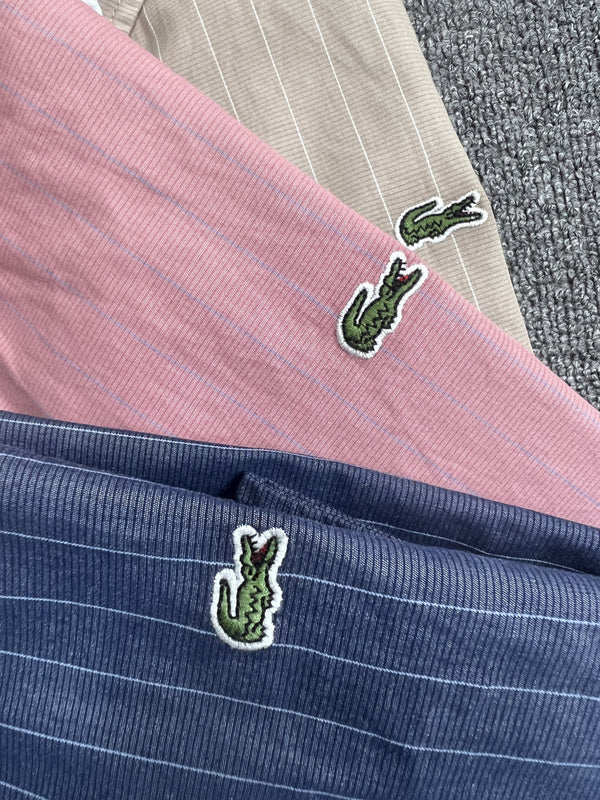 Front view of Lacoste luxury clothing with monogram-inspired silhouette