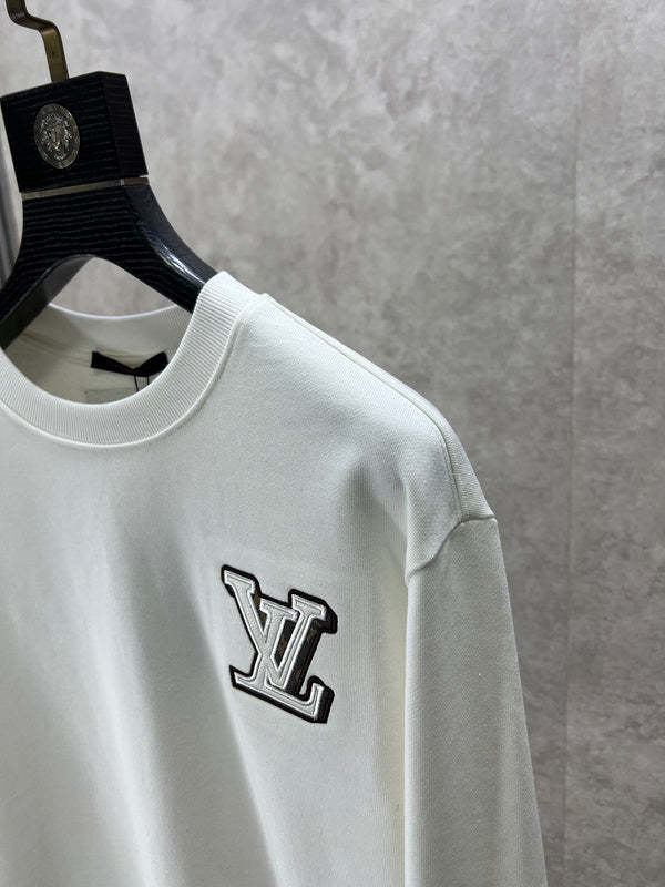Flat lay presentation of Louis Vuitton luxury clothing with logo-detail design