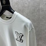 Flat lay presentation of Louis Vuitton luxury clothing with logo-detail design