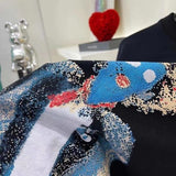 Flat lay presentation of Louis Vuitton luxury clothing with runway-inspired design