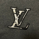 Flat lay presentation of Louis Vuitton luxury clothing with logo-detail design