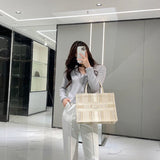 Front view of modern statement women's handbag – women's luxury accessory