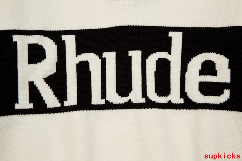 Flat lay presentation of Rhude luxury clothing with signature branding