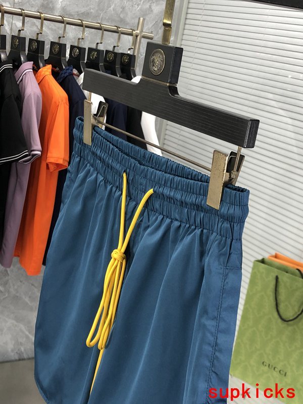 Flat lay presentation of Rhude luxury clothing with label-forward styling
