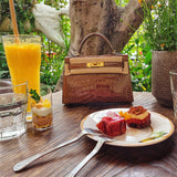  Elegant top-handle bag carried on shoulder