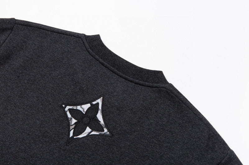 Side profile of Louis Vuitton luxury clothing with signature branding