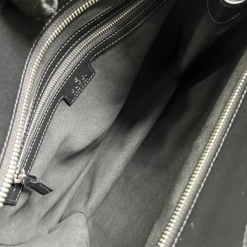 Side profile of statement classic women's handbag – women's luxury accessory