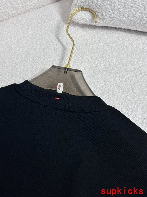 Side profile of Moncler luxury clothing with monogram-inspired silhouette