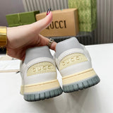 Side profile of Gucci crisp white sneakers retro runner design