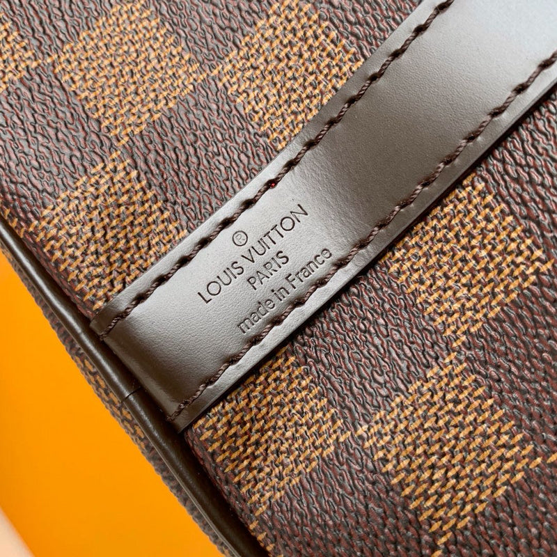 Side profile of polished signature women's handbag – women's luxury handbag