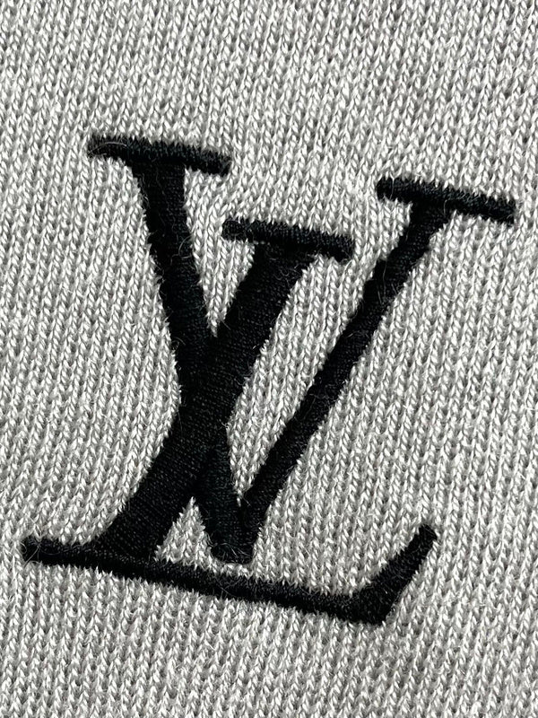 Flat lay presentation of Louis Vuitton luxury clothing with signature branding