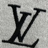 Flat lay presentation of Louis Vuitton luxury clothing with signature branding