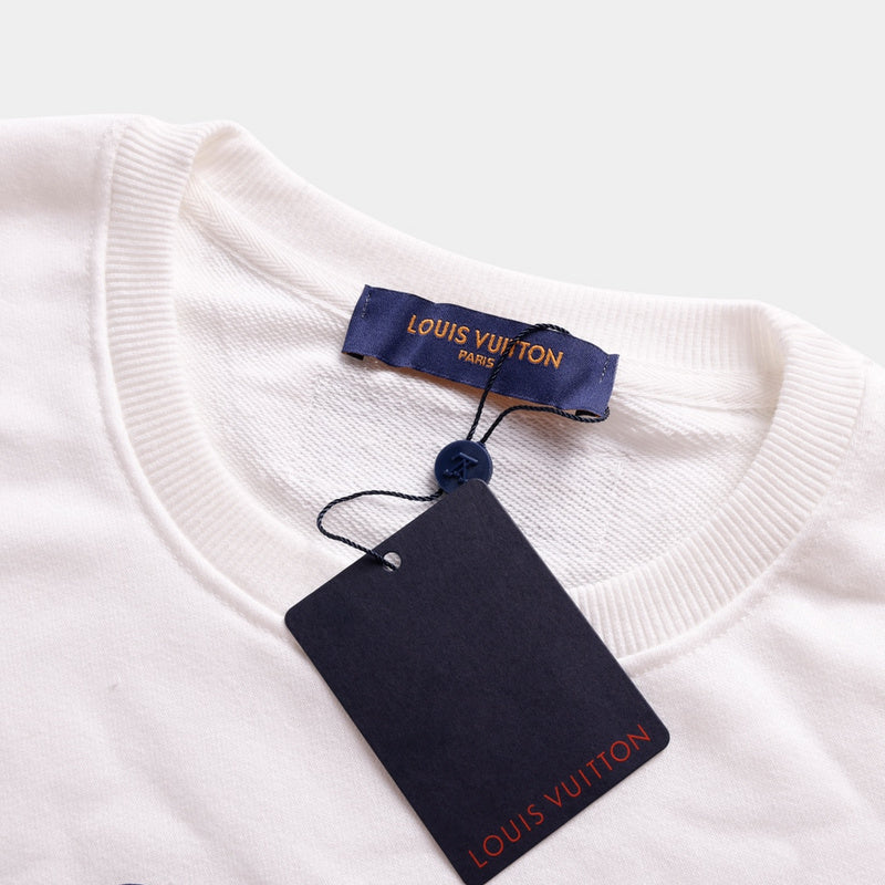 Close-up detail shot of Louis Vuitton luxury clothing with label-forward styling