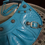 Side profile of elevated modern women's handbag – women's luxury accessory
