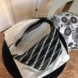Back view of classic sleek women's handbag – women's luxury accessory