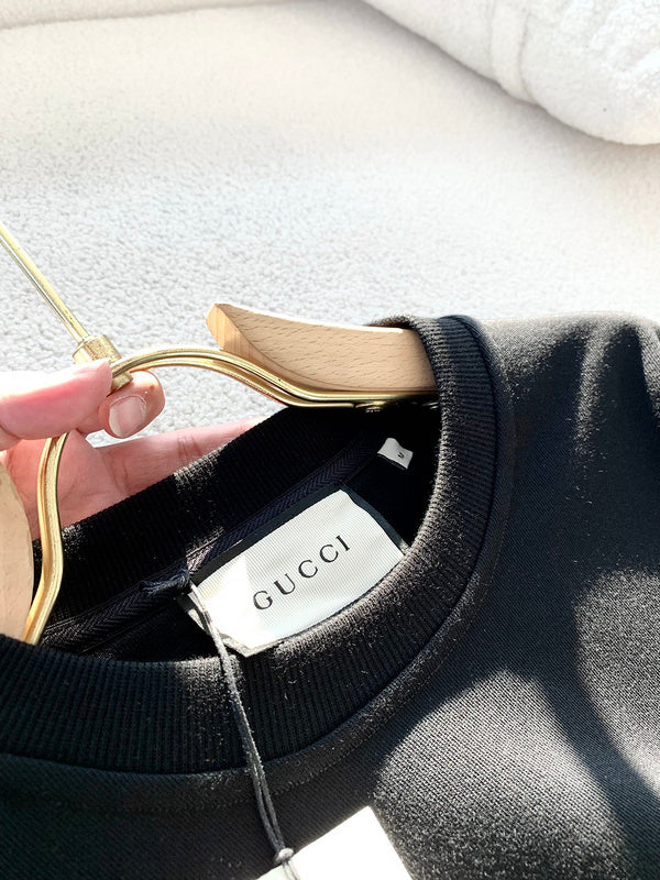 Back view of Gucci luxury clothing with monogram-inspired silhouette