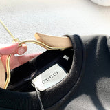 Back view of Gucci luxury clothing with monogram-inspired silhouette