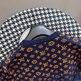 Full styled look of Louis Vuitton luxury clothing with label-forward styling