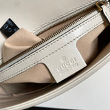 Side profile of elevated signature women's handbag – women's designer-style accessory