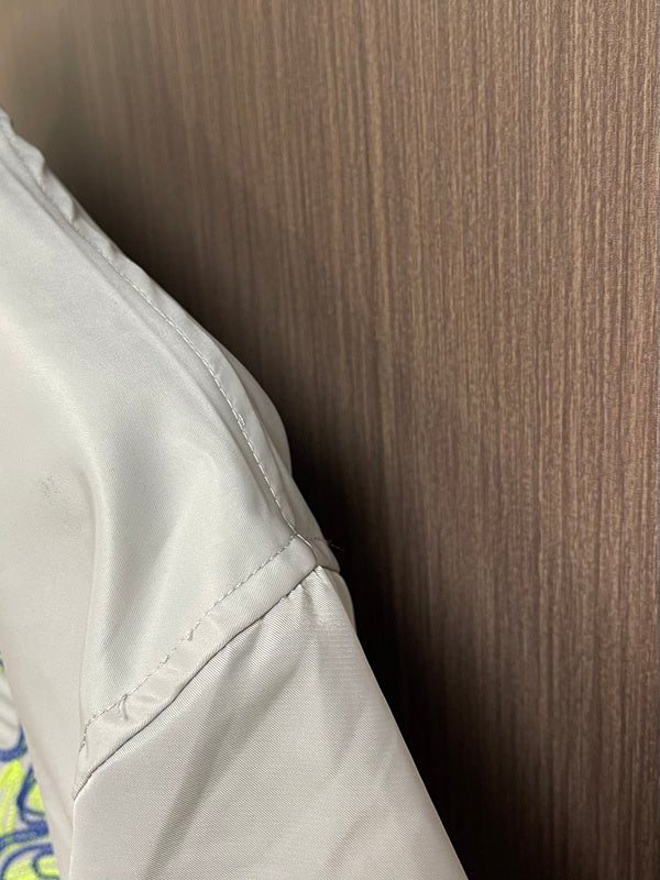 Close-up detail shot of Louis Vuitton luxury clothing with label-forward styling