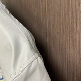 Close-up detail shot of Louis Vuitton luxury clothing with label-forward styling
