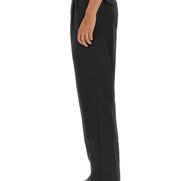Close-up of Alexander McQueen pants hardware and fine stitching