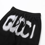 Close-up detail shot of Gucci luxury clothing with monogram-inspired silhouette
