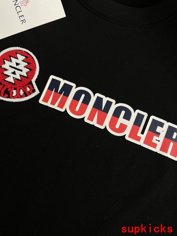 Flat lay presentation of Moncler luxury clothing with contemporary cut
