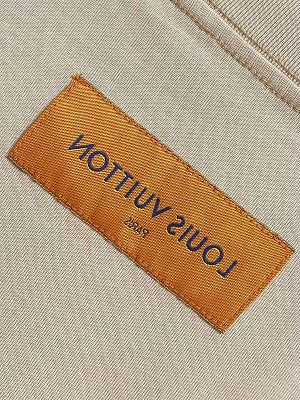 Close-up detail shot of Louis Vuitton cotton t-shirt with label-forward styling