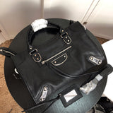 Handle and strap detail of modern refined women's handbag – women's luxury handbag