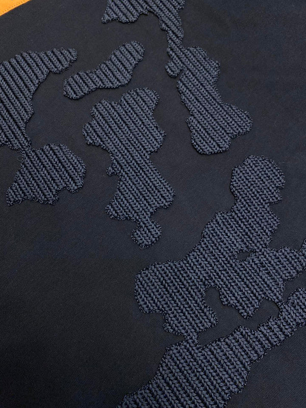 Close-up detail shot of Louis Vuitton luxury clothing with runway-inspired design