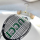 Close-up detail shot of Gucci luxury clothing with monogram-inspired silhouette
