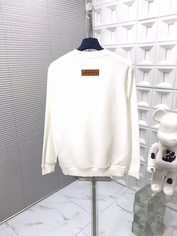 Flat lay presentation of Louis Vuitton luxury clothing with signature branding