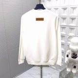 Flat lay presentation of Louis Vuitton luxury clothing with signature branding