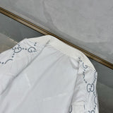 Flat lay presentation of Gucci luxury clothing with logo-detail design