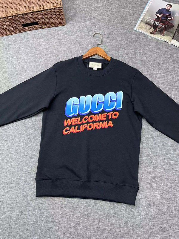 Flat lay presentation of Gucci luxury clothing with signature branding