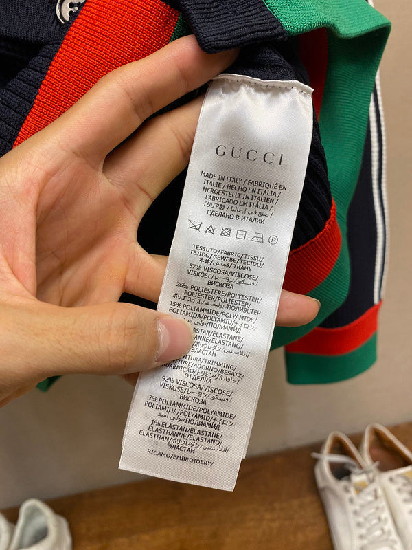 Side profile of Gucci luxury clothing with label-forward styling