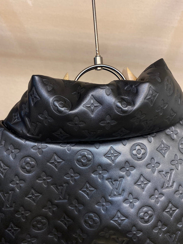 Close-up detail shot of Louis Vuitton luxury clothing with label-forward styling