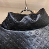 Close-up detail shot of Louis Vuitton luxury clothing with label-forward styling