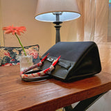 Side view of fluid structured handbag